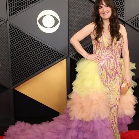 Sara Gazarek on the GRAMMY red carpet in a tiered pink and yellow gown.