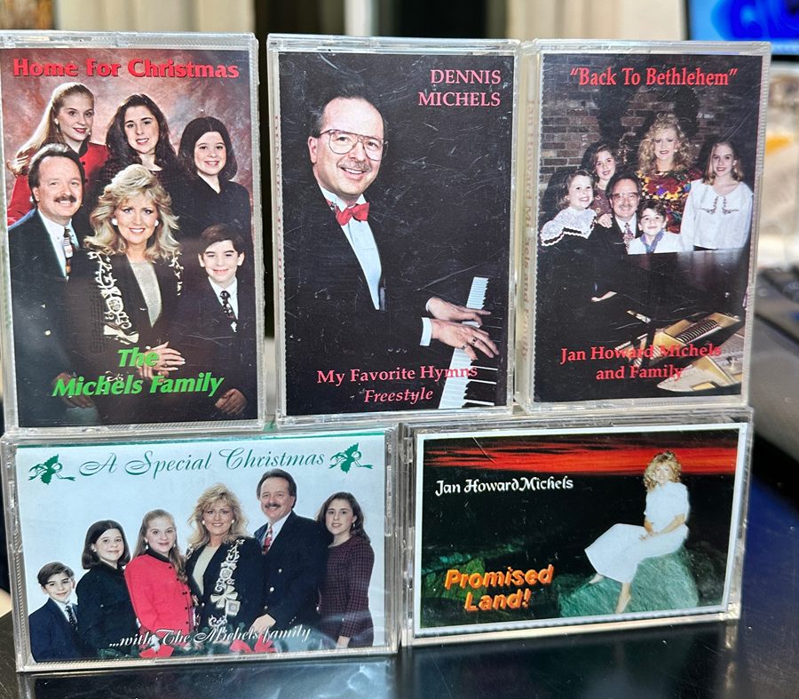 Five Michels family cassettes in their cases: Home For Christmas, Dennis Michels My Favorite Hymns Freestyle, Back To Bethlehem, A Special Christmas, and Jan Howard Michels Promised Land.