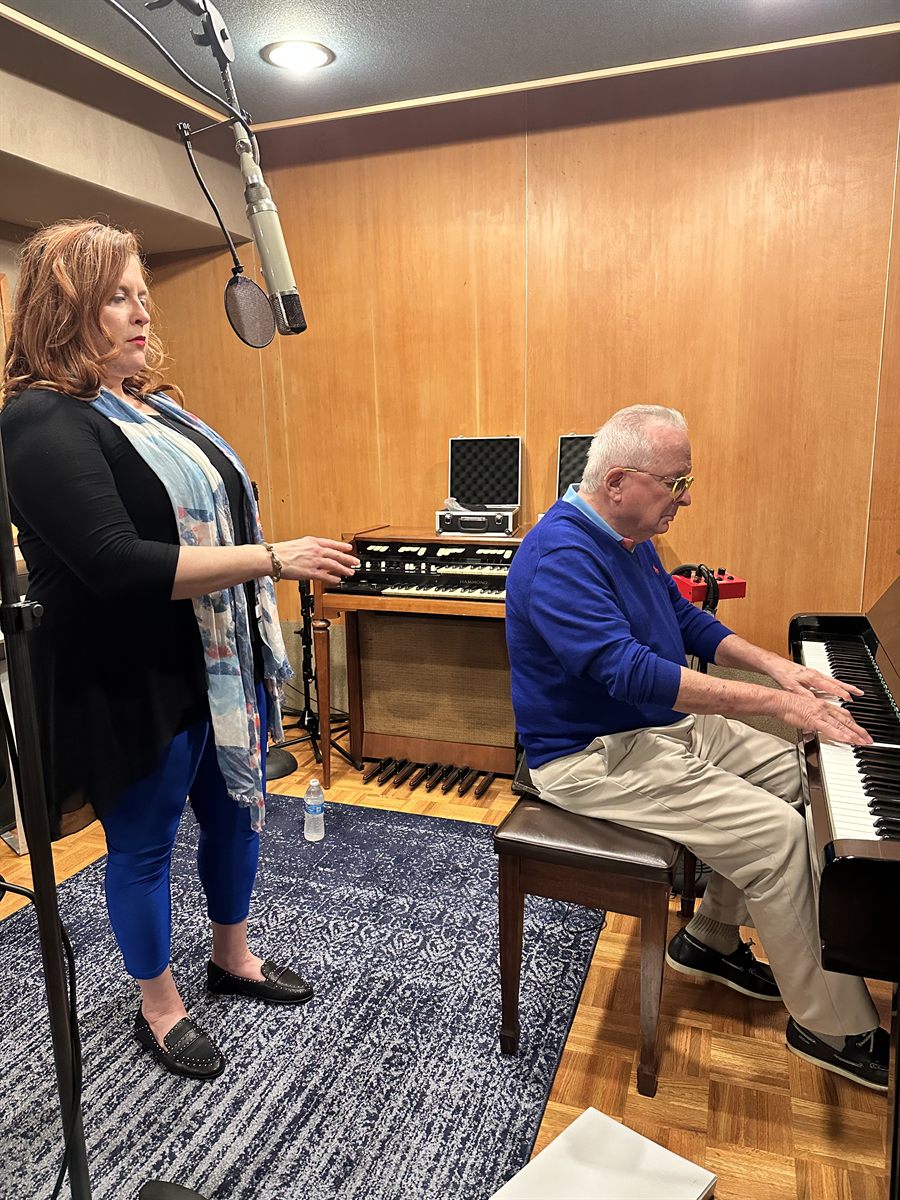 Jenn Quader standing at a Hammond organ while Dr. Dennis Michels plays the piano beside her in the LMNL live room.