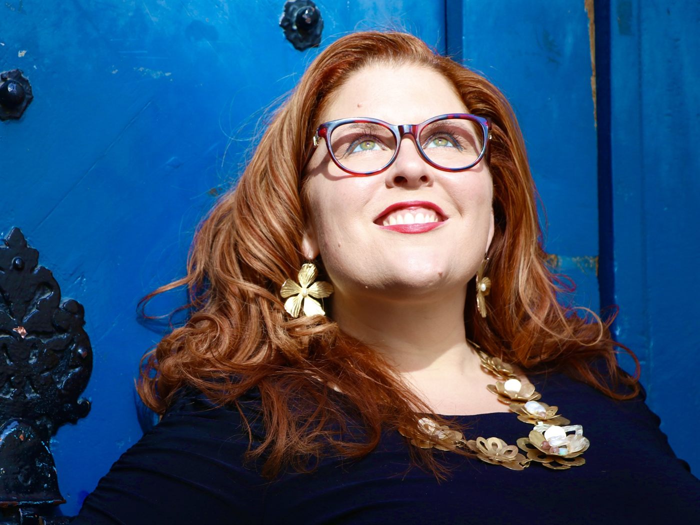 Jenn Quader photographed outdoors, smiling.